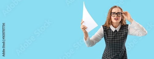 Photos Worried actress holding movie script on blue background with space for text