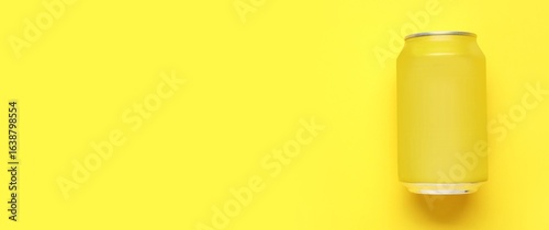 Can of soda on yellow backg...