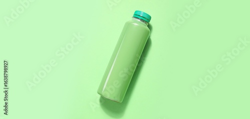 Bottle of soda on green bac...