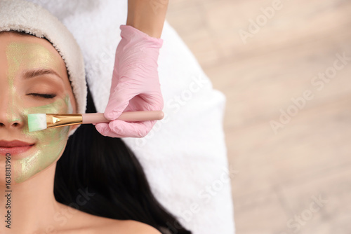 Young woman receiving facia...