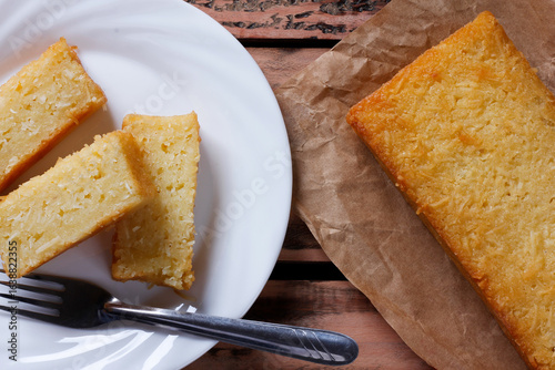 Traditional homemade cassava cake whit coconut on a rustic wooden table