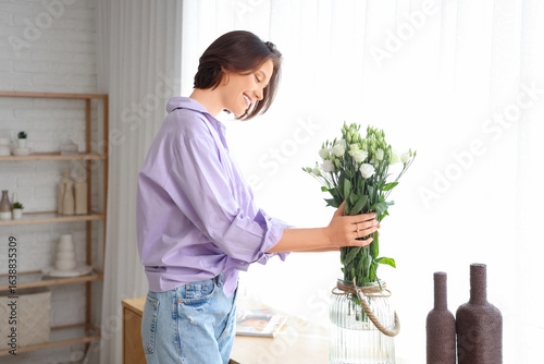 Young woman with eustoma fl...