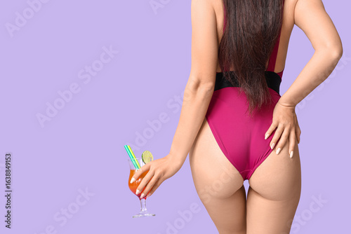 Woman in pink swimsuit hold...