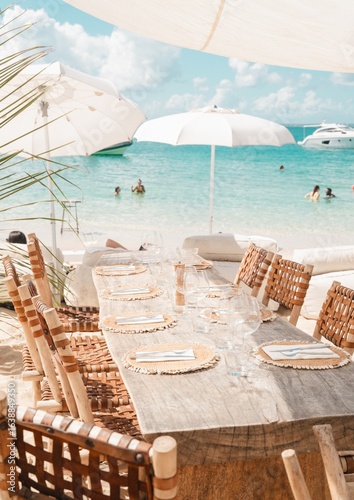 Photography caribbean saint martin beach club wooden table setting with turquoise ocean view