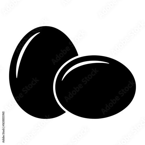Two black eggs on white oval food