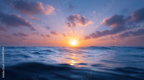 Ocean Sunset Serenity: The sun dips below the horizon, painting the sky with vibrant hues and casting a warm glow on the tranquil ocean waves. Capturing a moment of peace.