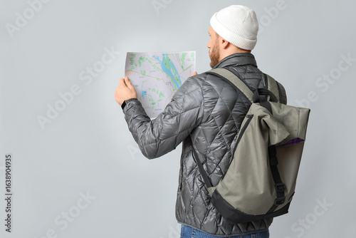 Young male tourist with bac...