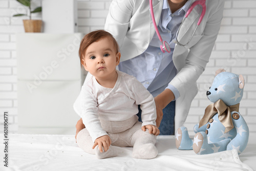 Female pediatrician with cu...
