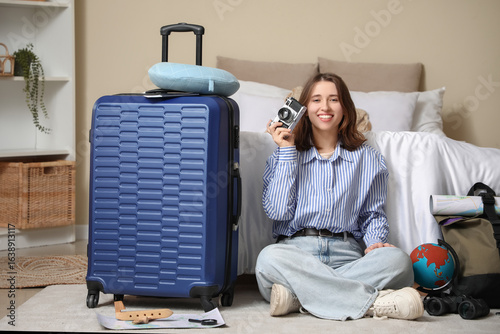 Female traveler with photo ...
