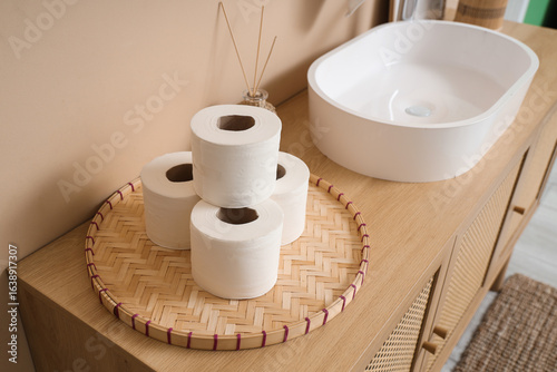 Wicker mat with rolls of to...