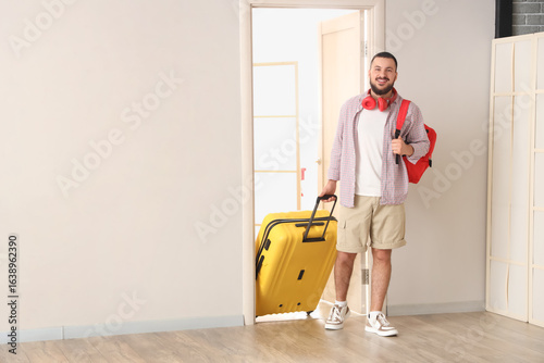 Male tourist with bags walk...