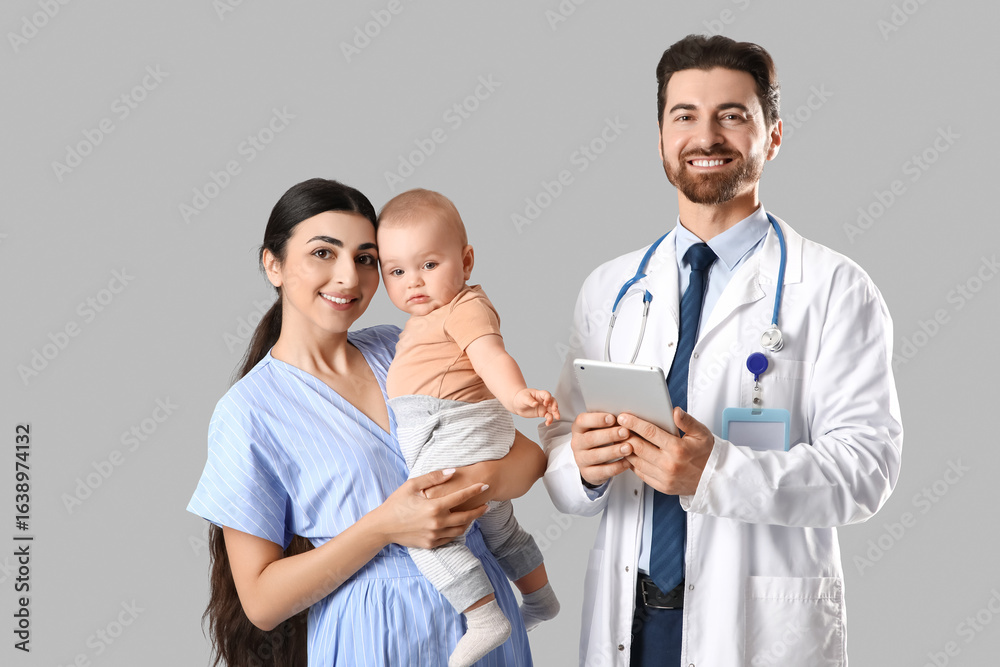 Fototapeta premium Mother with her little baby and pediatrician on grey background