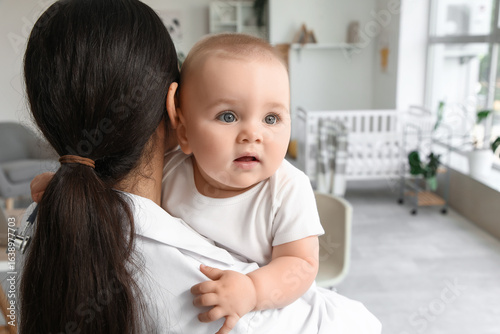 Female pediatrician holding...