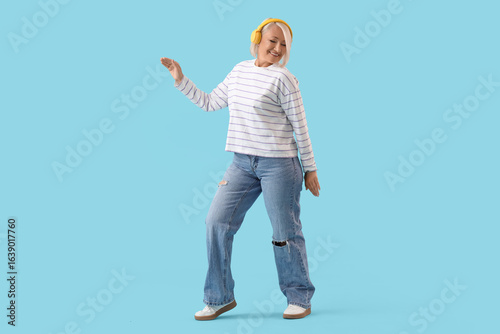 Mature woman in headphones ...