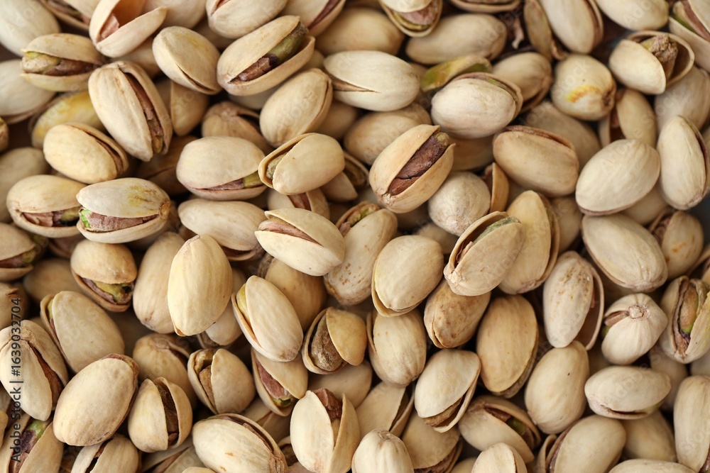 Tasty unpeeled pistachios as background, top view flat lay background Tasty unpeeled pistachios as background, top view flat lay background