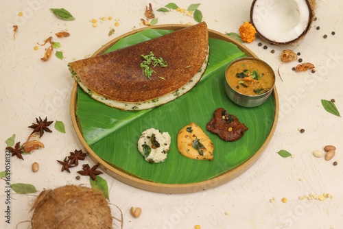 Sticker Maysore masala dosa with sambhar and coconut chutney on banana leaf