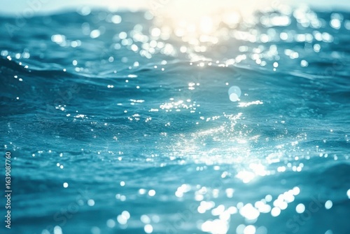 Close-up of ocean water surface with sunlight reflecting and sparkling on gentle waves creating a serene and calming atmosphere