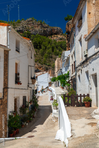 Town street decorated with flowers, in Molinicos village, Castilla la Mancha, Spain.