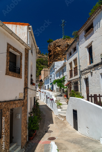 Town street decorated with flowers, in Molinicos village, Castilla la Mancha, Spain.