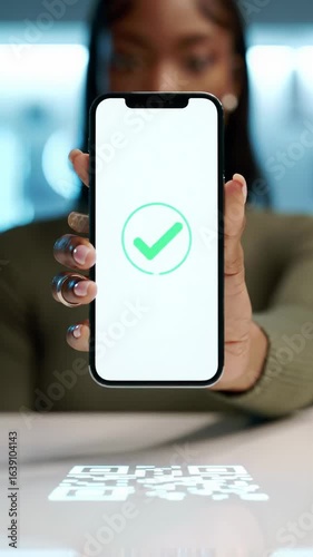 Tight close-up vertical video of a diverse, well-groomed hand holding a sleek, futuristic smartphone over a glowing QR code on a pristine reflective surface, display shows success, effortless modern