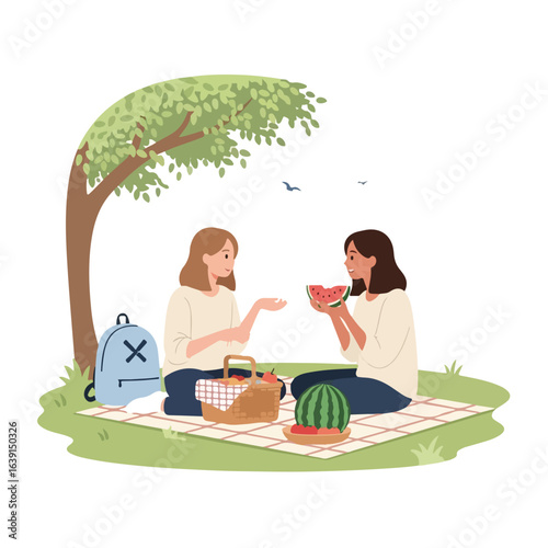 Picnic with friends enjoying slices of watermelon under tree, a simple scene of two women sharing watermelon. Relaxing picnic with friends involves a basket and a blanket spread on the grass.