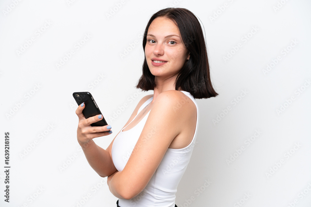 Young caucasian woman isolated on white background holding a mobile phone and with arms crossed Young caucasian woman isolated on white background holding a mobile phone and with arms crossed
