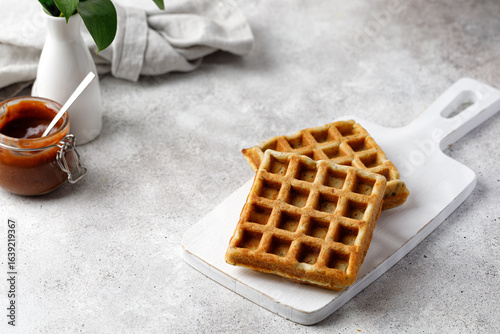 Breakfast waffles with chocolate sauce. Waffles empty on white board