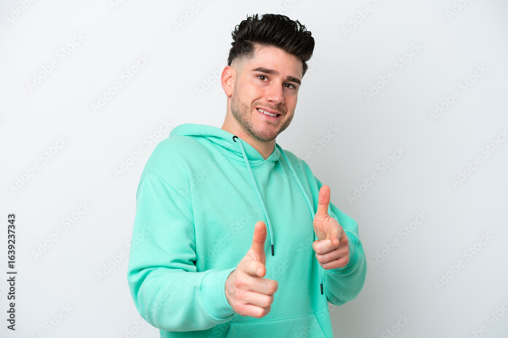 Fototapeta premium Young caucasian man isolated on white background pointing to the front and smiling