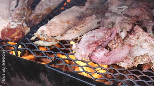 Grilling pork meat over fire 