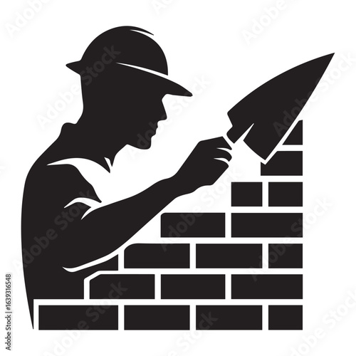 Silhouette of a construction worker laying bricks with a trowel while wearing a hard hat at work