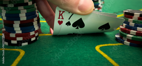 Canvas Print Close Up Shot On Hand Of Anonymous Poker Player Checking Playing Cards He Was Dealt
