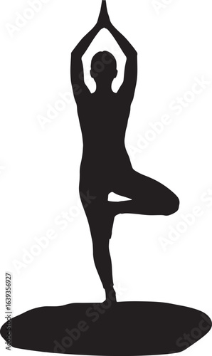 Silhouette of a woman practicing yoga in tree pose on a mat