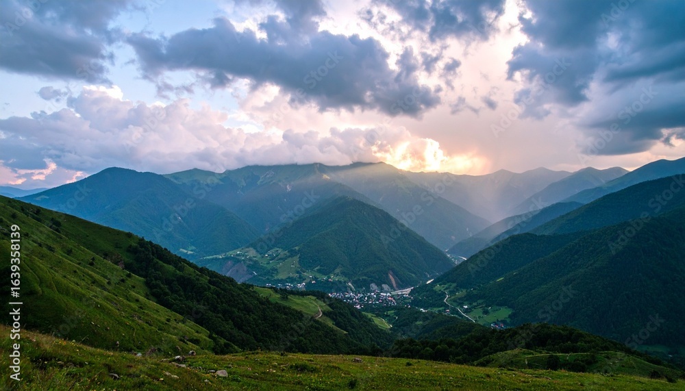 Fototapeta premium Countryside landscape with rolling hills, sunlit meadows, and dramatic light streaming through partly cloudy skies.