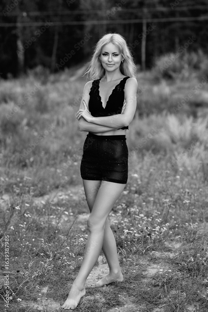 Portrait of a young beautiful blonde girl in light clothes outdoors in summer. Black and white photo. Portrait of a young beautiful blonde girl in light clothes outdoors in summer. Black and white photo.