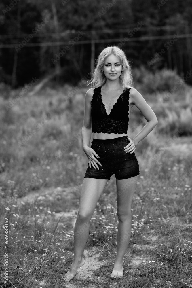 Portrait of a young beautiful blonde girl in light clothes outdoors in summer. Black and white photo. Portrait of a young beautiful blonde girl in light clothes outdoors in summer. Black and white photo.