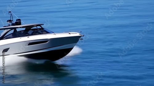 Gray and white motorboat speeds across a deep blue ocean
