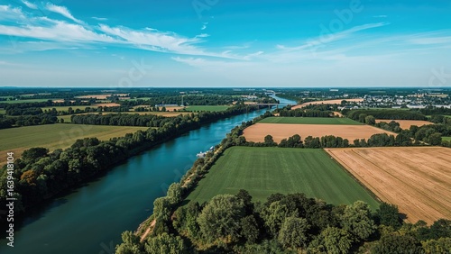 Captivating top-down perspective of peaceful river flowing through fertile farmland in a northern district