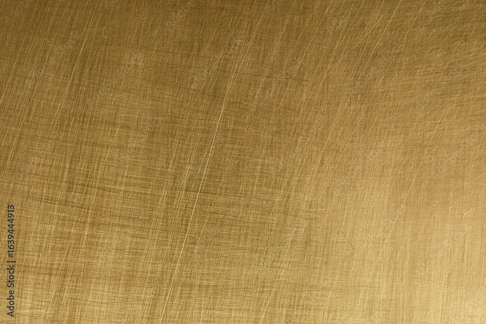 Fototapeta premium High-resolution image of brushed gold metal texture. Perfect for backgrounds, designs, and more.