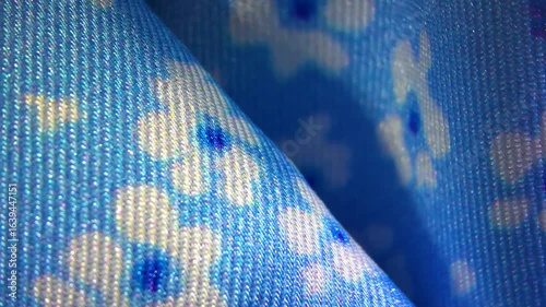 Blue with white flower pattern viscose silk textile material cloth texture blur background macro