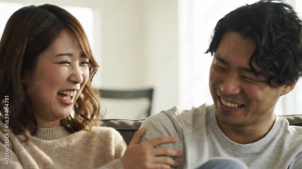 A smiling couple shares a moment of laughter and joy while enjoying each other's company indoors, creating a warm atmosphere. A smiling couple shares a moment of laughter and joy while enjoying each other's company indoors, creating a warm atmosphere.
