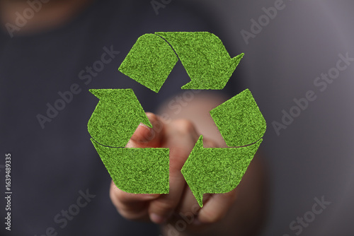 Hand pointing at a green re...