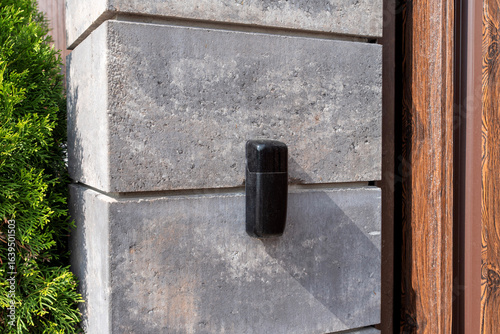 Gate post with black photocell sensor for automatic gates