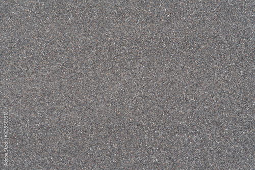 Natural seamless gray stone granules texture, gravel aggregate surface background