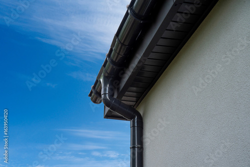 Plastic rain gutter on house eaves