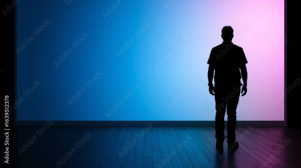 Fototapeta premium Silhouette of a person standing against a vibrant blue-purple gradient backdrop.