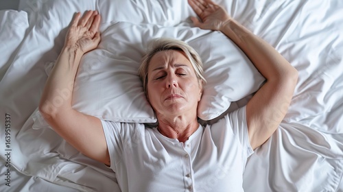 Menopause, night sweat. Woman suffering from hot flash in bed