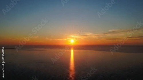 Sunset Over Calm Waters with Orange and Blue Sky Reflections on Horizon — 4K HD Video Footage Download, Serene Peaceful Tranquil Atmospheric Landscape