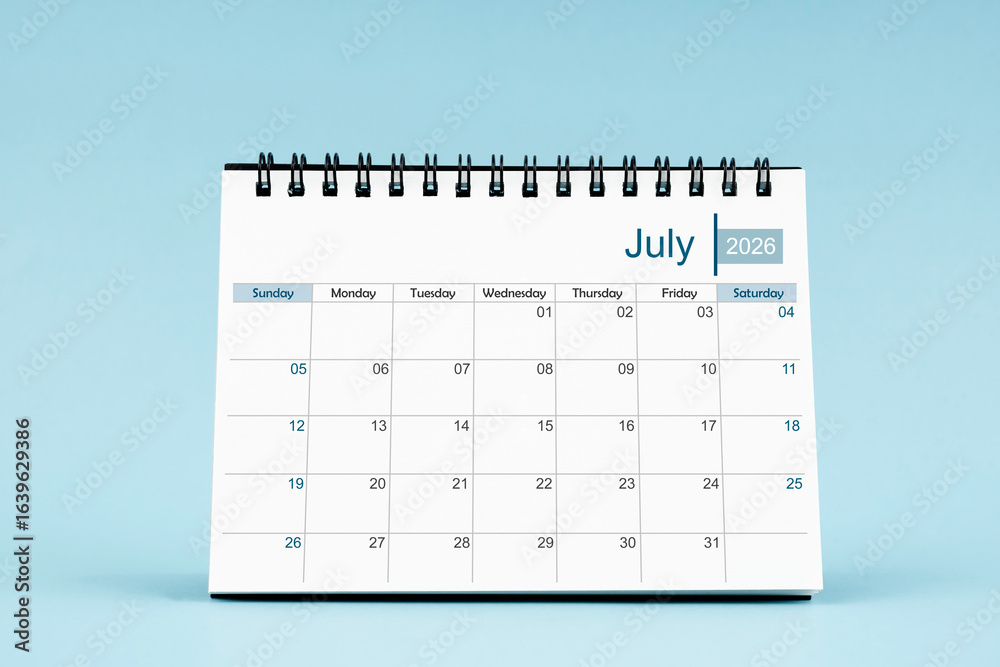 July 2026 Monthly desk calendar for 2026 year on soft blue color background. July 2026 Monthly desk calendar for 2026 year on soft blue color background.