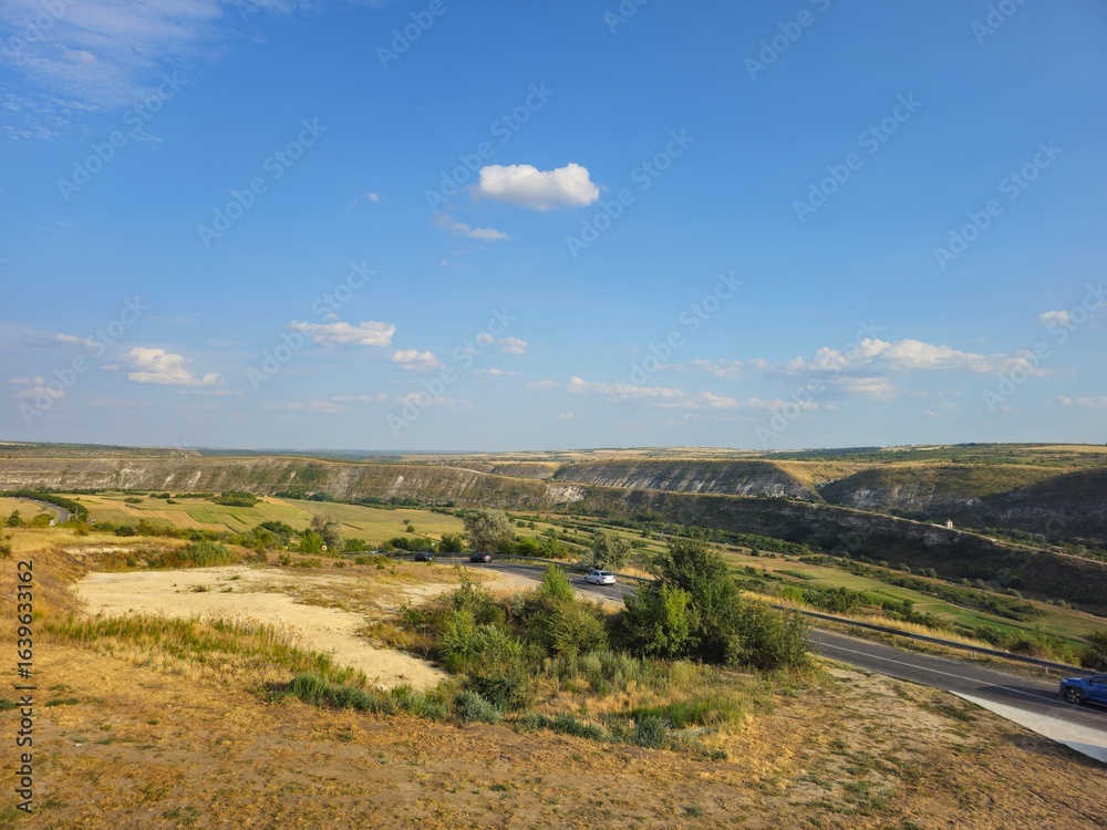 Naklejka premium A landscape with a road and a blue sky