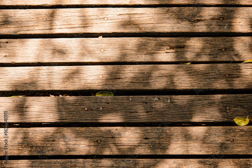 Old wooden background with sunlight shining on the floo